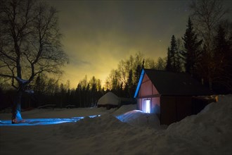 Light glowing in remote barn in winter