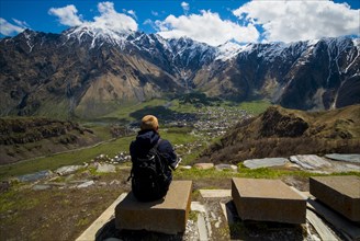 Caucasian man admiring scenic view of village in valley