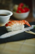 Shrimp on rice with chopsticks