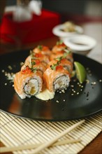 Sushi on plate with chopsticks