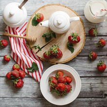 Strawberries and cream on wooden table
