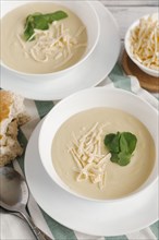 Bowls of cheese soup on table