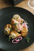 Chicken on plate with onions and garnish