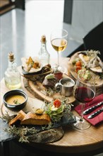 Variety of meat and fish on table with wine