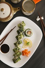 Sushi on plate with lemon and ginger