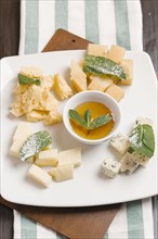 Variety of cheeses on plate with sauce