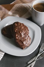 Chocolate cookies with nuts on plate