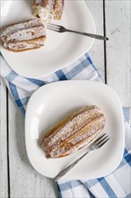 Pastry with powdered sugar on plate with fork