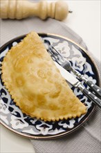 Pastry on plate with fork and knife