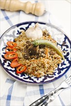 Pepper and onion on plate with beef and rice