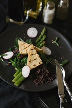 Slices of radish and asparagus on plate