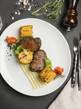 Grilled beef and corn on plate