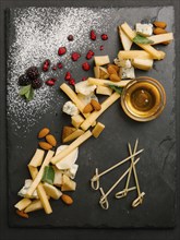 Cheese and nuts with honey on slate