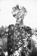 Double exposure of Middle Eastern woman and tree branches