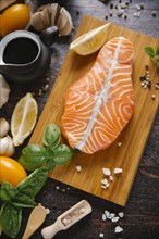 Raw salmon on cutting board with ingredients