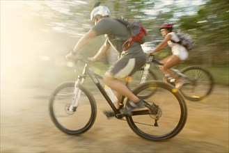 Blurred view of couple riding mountain bikes