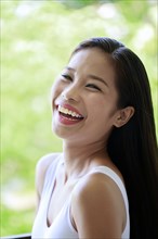 Portrait of laughing Asian teenage girl
