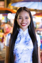 Portrait of smiling Asian woman wearing traditional clothing