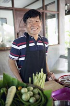 Smiling Thai man preparing food