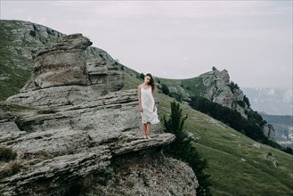 Caucasian woman standing on rock overlooking landscape
