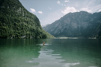 Caucasian man swimming in mountain lake