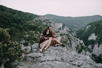 Caucasian women hugging on mountain