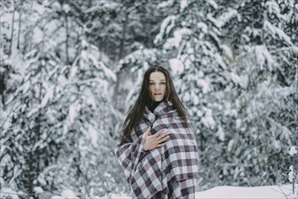 Portrait of Caucasian woman in snowy forest