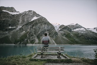 Caucasian man admiring scenic view of mountain lake