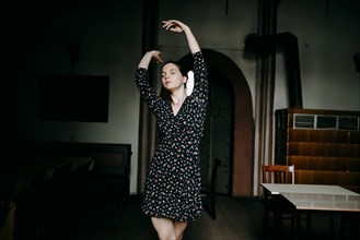 Caucasian woman dancing in livingroom