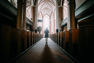 Caucasian woman standing in aisle of church
