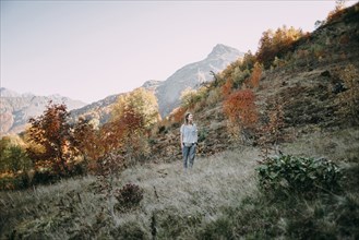Caucasian woman hiking on mountain in autumn