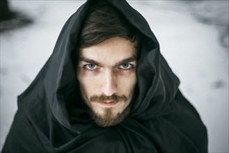 Caucasian man with beard wearing robe in winter