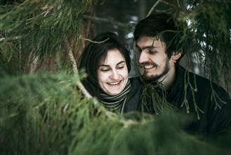 Caucasian couple smiling near tree