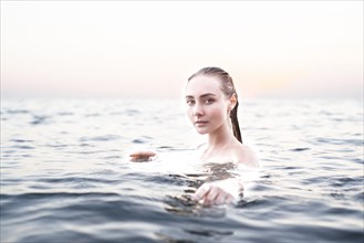 Portrait of serious location woman swimming