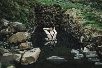 Caucasian woman swimming in pond