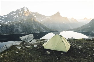Camping tent near mountain lake
