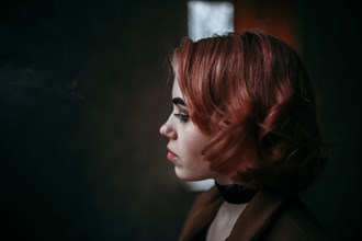 Pensive Caucasian woman with red hair