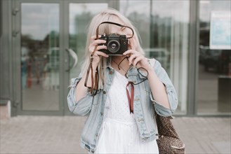 Caucasian woman photographing with camera