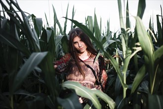 Caucasian woman standing in cornfield