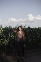 Caucasian woman standing in cornfield