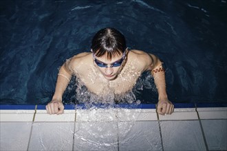 Caucasian man wearing goggles in swimming pool