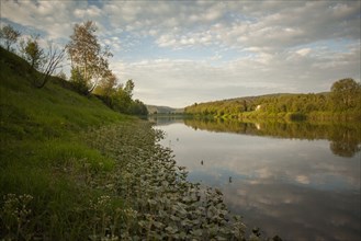 Still river in rural landscape