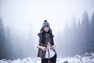 Caucasian woman standing in snowy woods