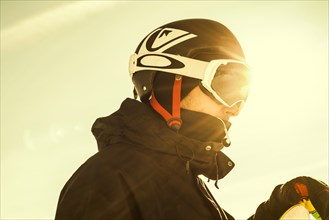 Caucasian man wearing ski goggles and helmet outdoors