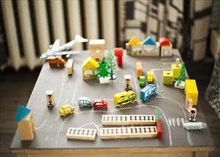 Wooden buildings and car toys on table
