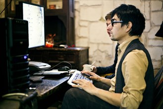Men using computer at desk