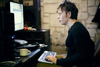 Caucasian man using computer at desk