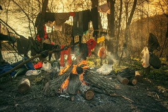 Clothes hanging over fire at campsite
