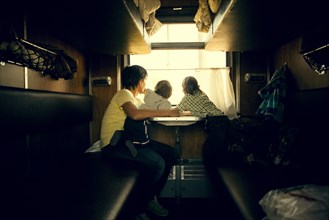 Father and children looking out trailer window
