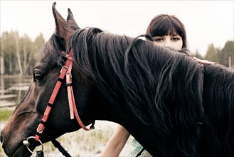 Caucasian woman with horse outdoors
